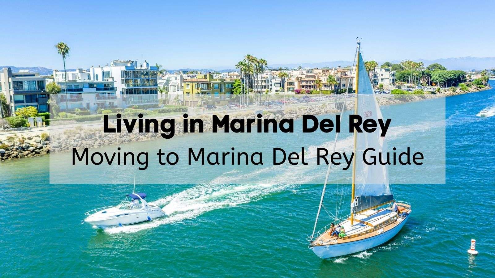 View of Marina Del Rey in Los Angeles, California, from the water with a sailboat and speedboat in the foreground